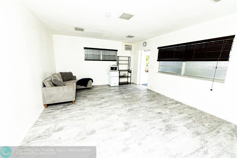 3515 Van Buren Street, Unit A Hollywood, FL 33021 - Photo 8 of 11 a living room with furniture and a flat screen tv