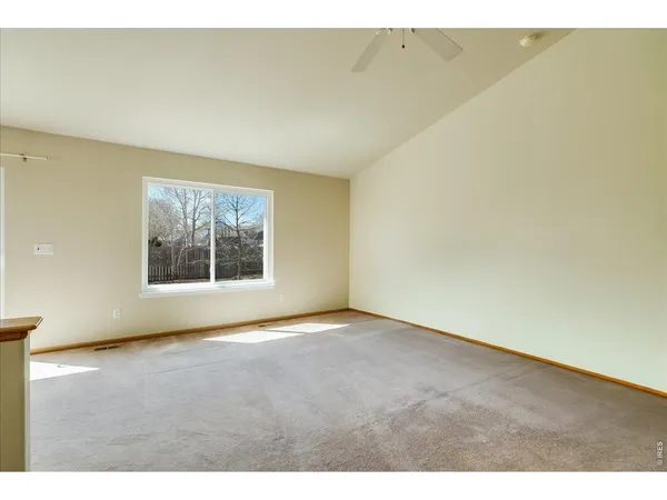 a view of a kitchen with a refrigerator a microwave and a sink