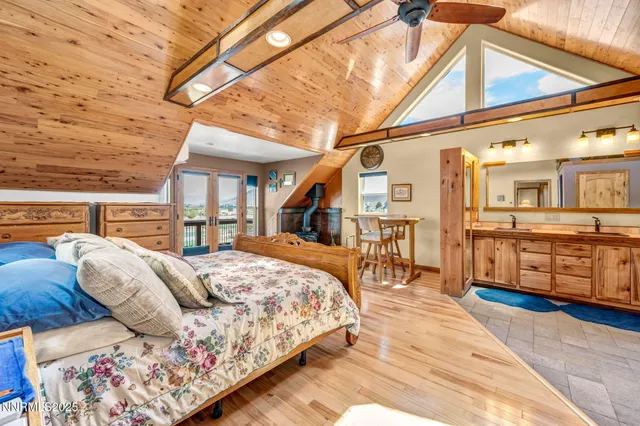a bedroom with a large bed and a chandelier
