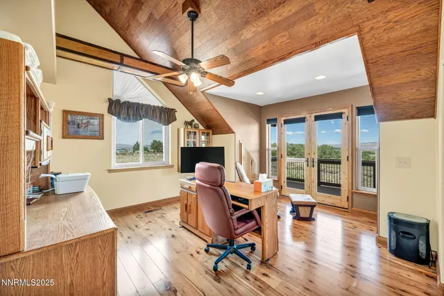 a living room with furniture a fireplace and wooden floor