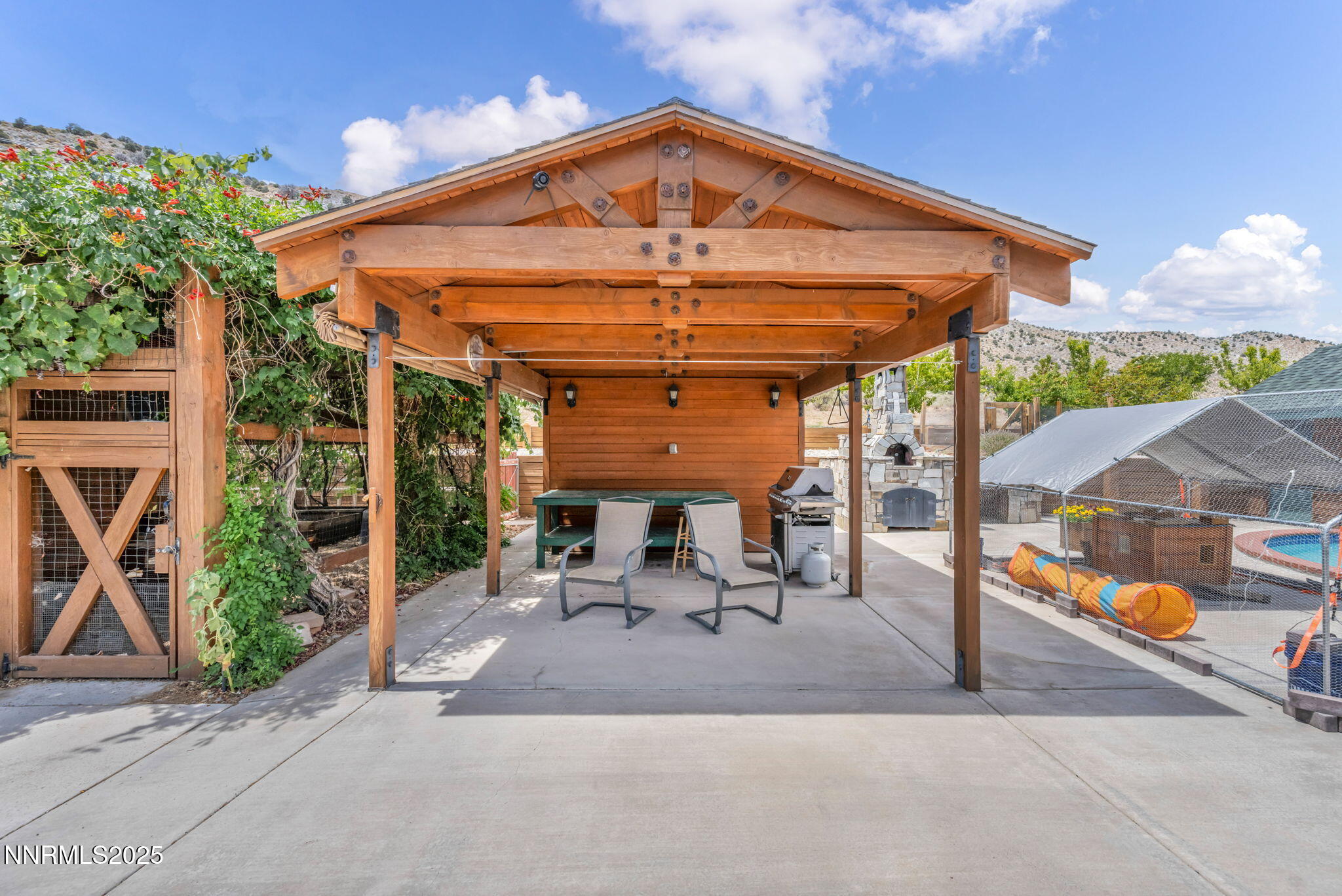 111 Upper Colony Road Wellington, NV 89444 - Photo 31 of 49 a view of a patio with table and chairs under an umbrella