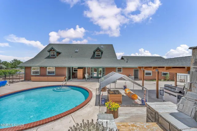 a front view of a house with a garden and patio