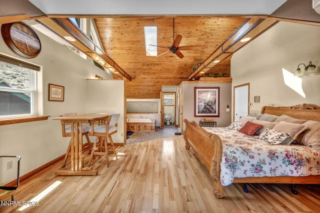 a bedroom with furniture and wooden floor