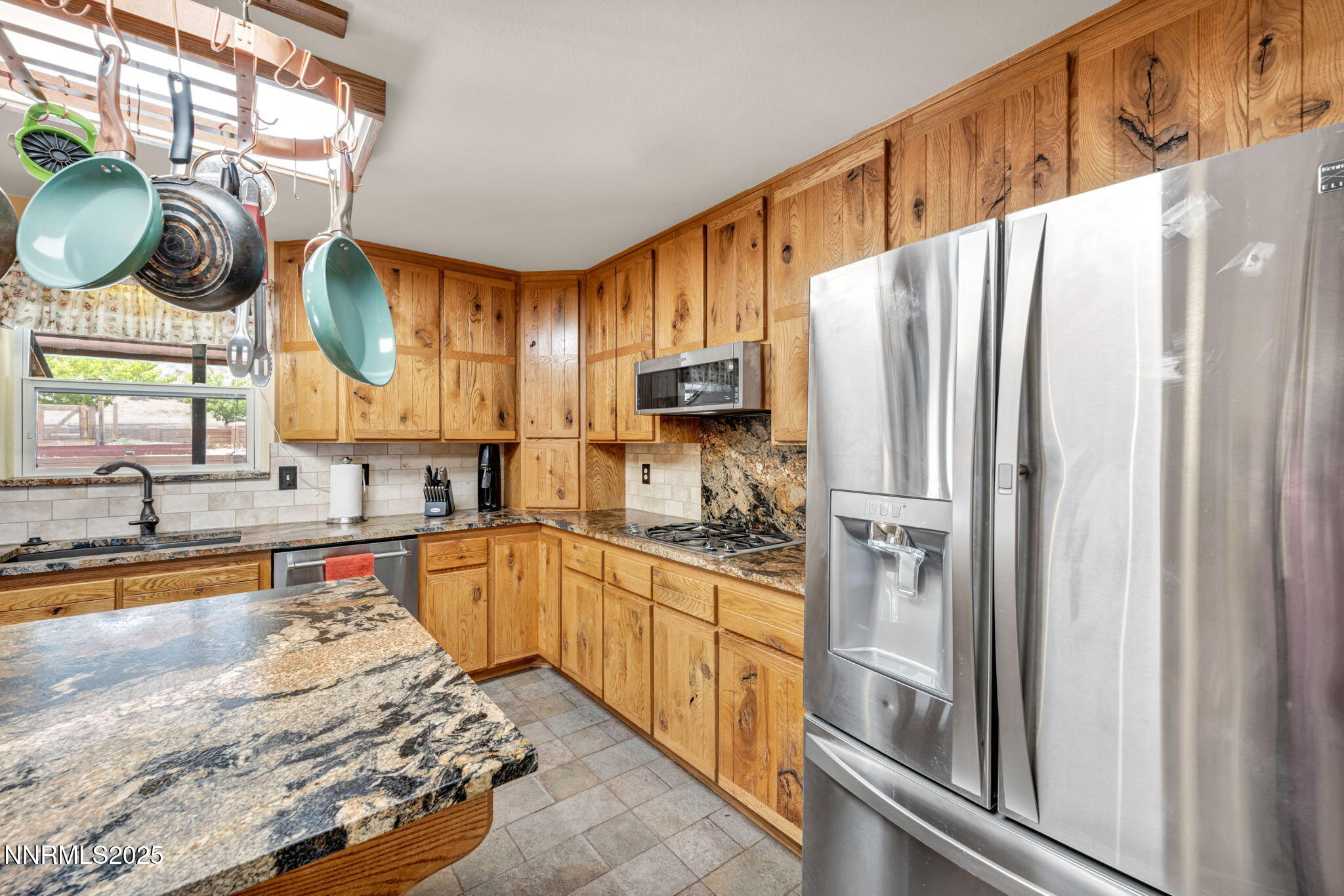 111 Upper Colony Road Wellington, NV 89444 - Photo 10 of 49 a kitchen with stainless steel appliances granite countertop a refrigerator and a stove top oven