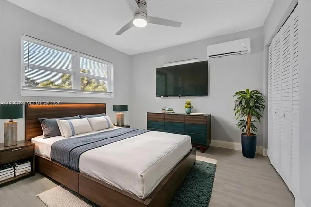 a bedroom with a bed and a flat screen tv