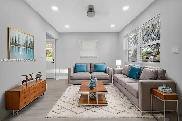 a living room with furniture and a large window