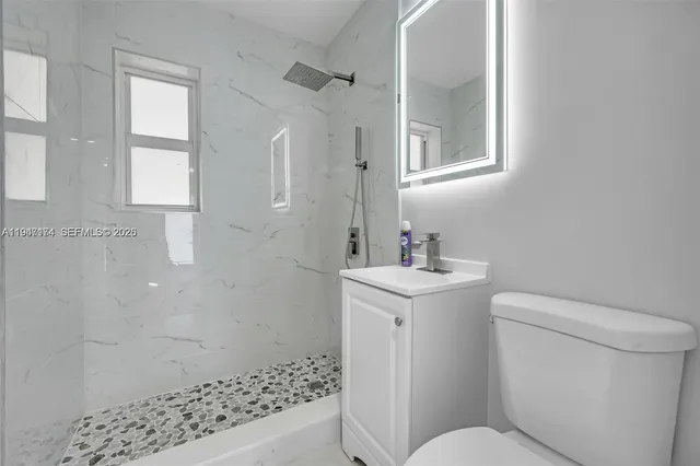 a bathroom with a sink toilet and shower
