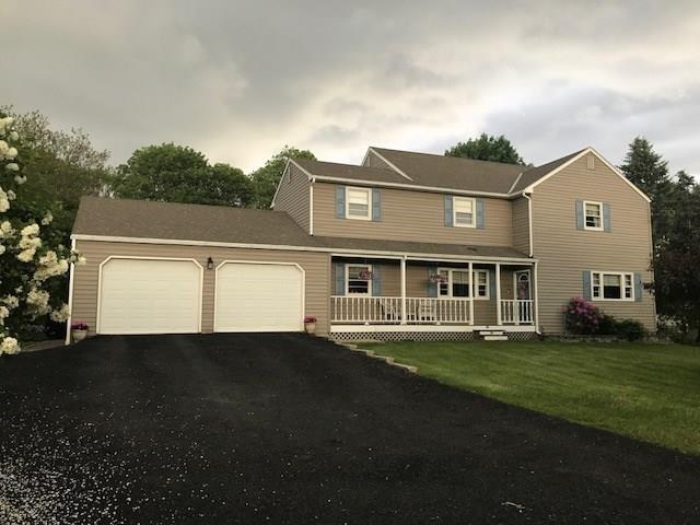 a front view of a house with a yard