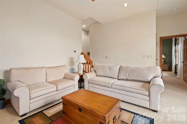 a spacious bedroom with a bed and painting on the wall