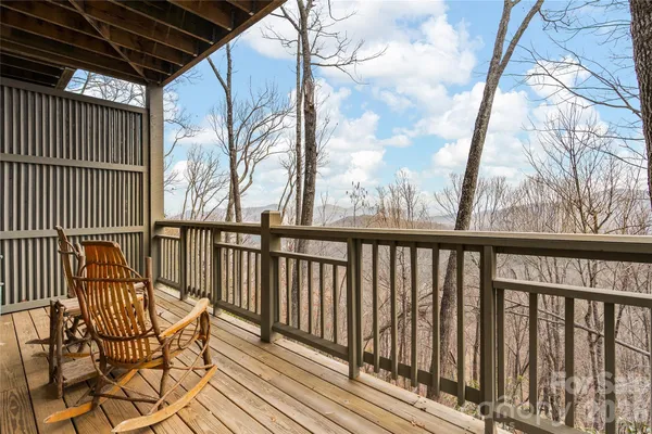 a living room with a couch a fireplace and a floor to ceiling window