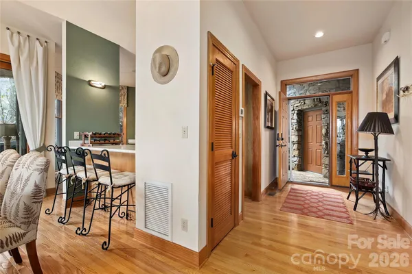 a kitchen with a stove a refrigerator and a dining table