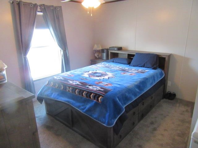 3251 E Road, Unit 99 Clifton, CO 81520 - Photo 19 of 25 a bed sitting in a bedroom next to a window