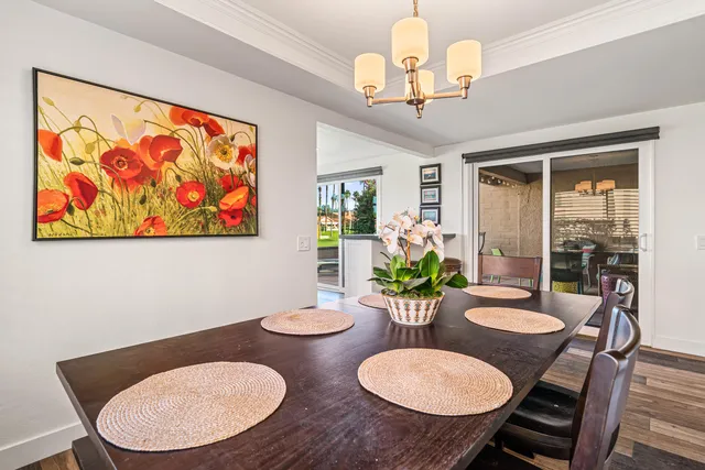 a metallic refrigerator freezer sitting inside of a kitchen