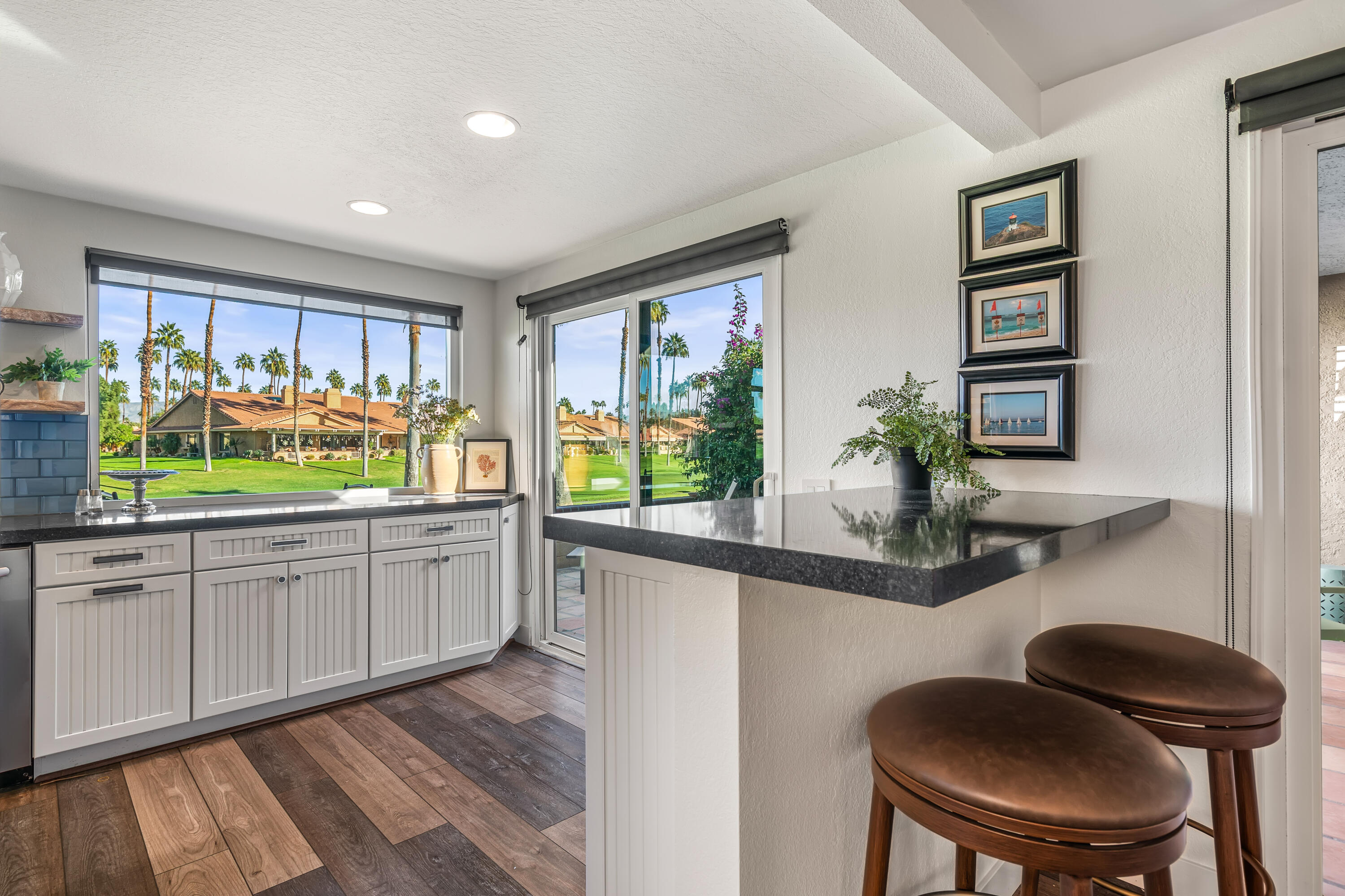 82 Conejo Circle Palm Desert, CA 92260 - Photo 13 of 58 a kitchen with a chair and cabinets