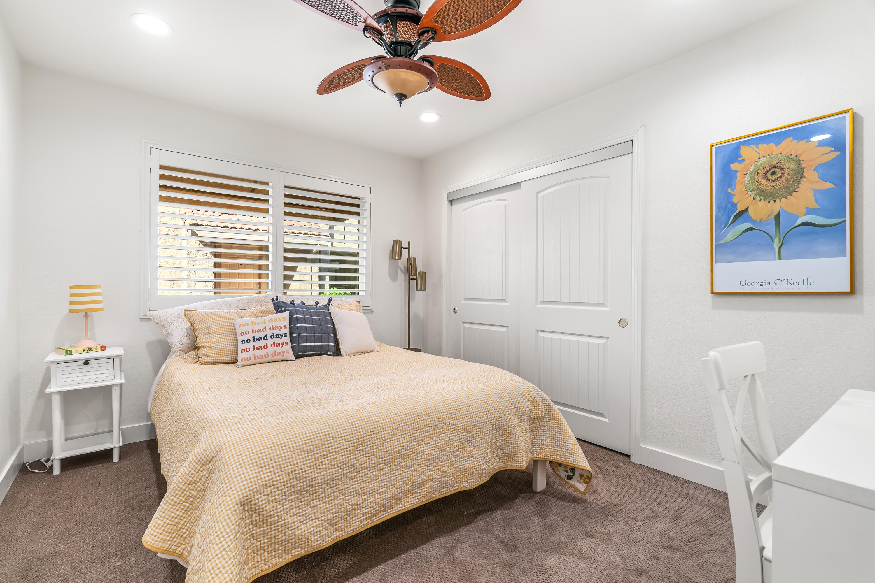 82 Conejo Circle Palm Desert, CA 92260 - Photo 23 of 58 a bedroom with a bed and a chandelier