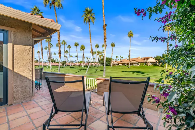 a kitchen with stainless steel appliances granite countertop a sink and a white cabinets