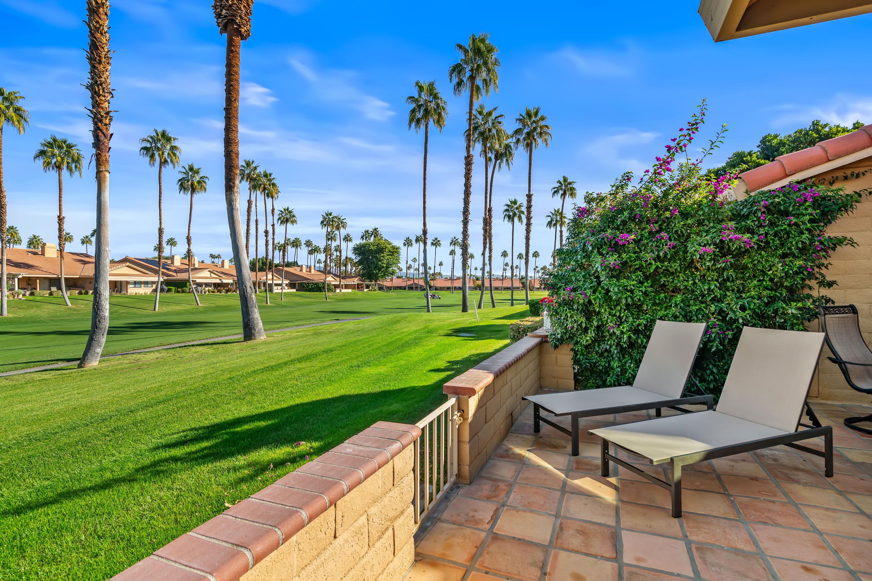 82 Conejo Circle Palm Desert, CA 92260 - Photo 31 of 58 a view of a chairs and table on the patio