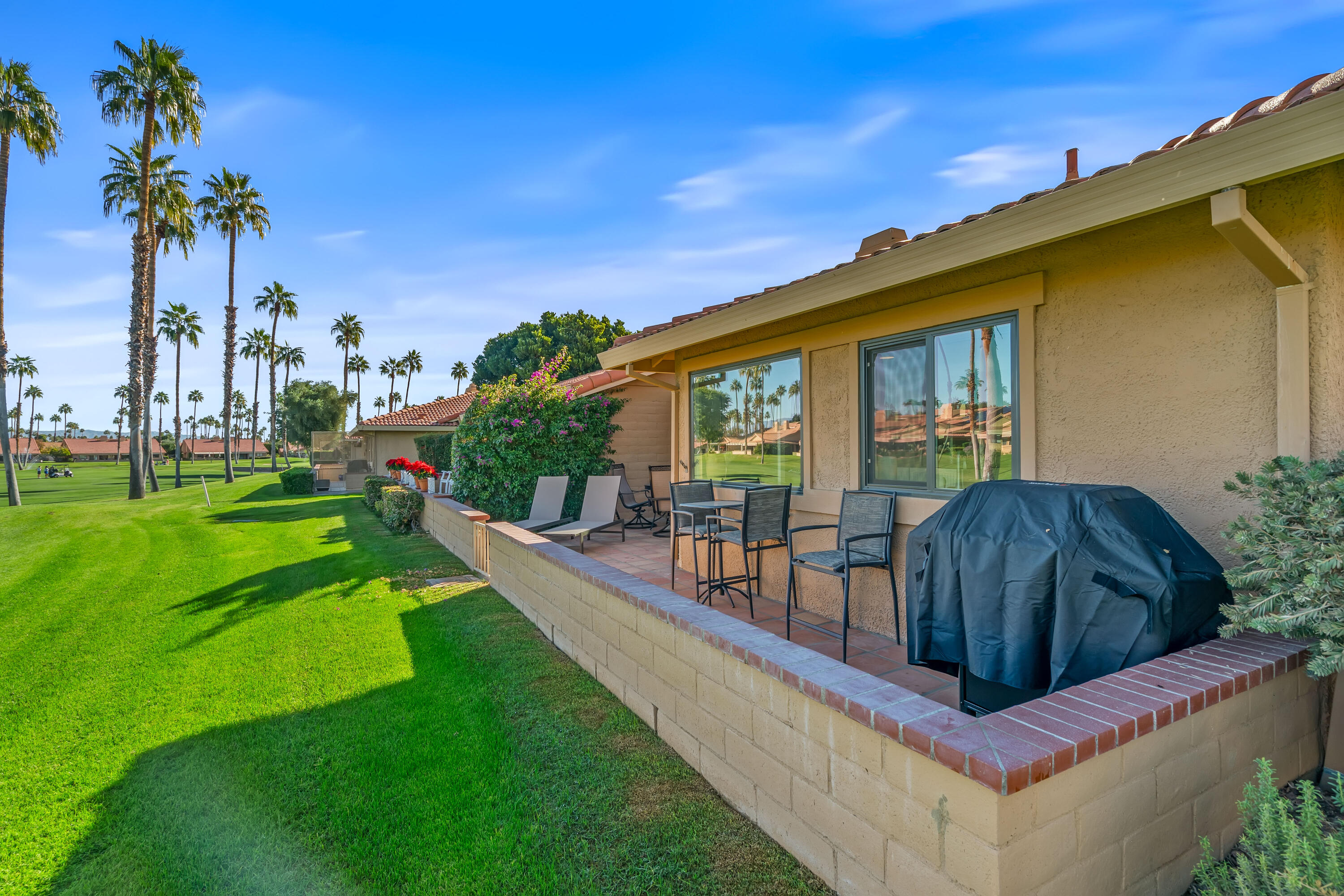 82 Conejo Circle Palm Desert, CA 92260 - Photo 34 of 58 a view of a backyard with a garden and plants