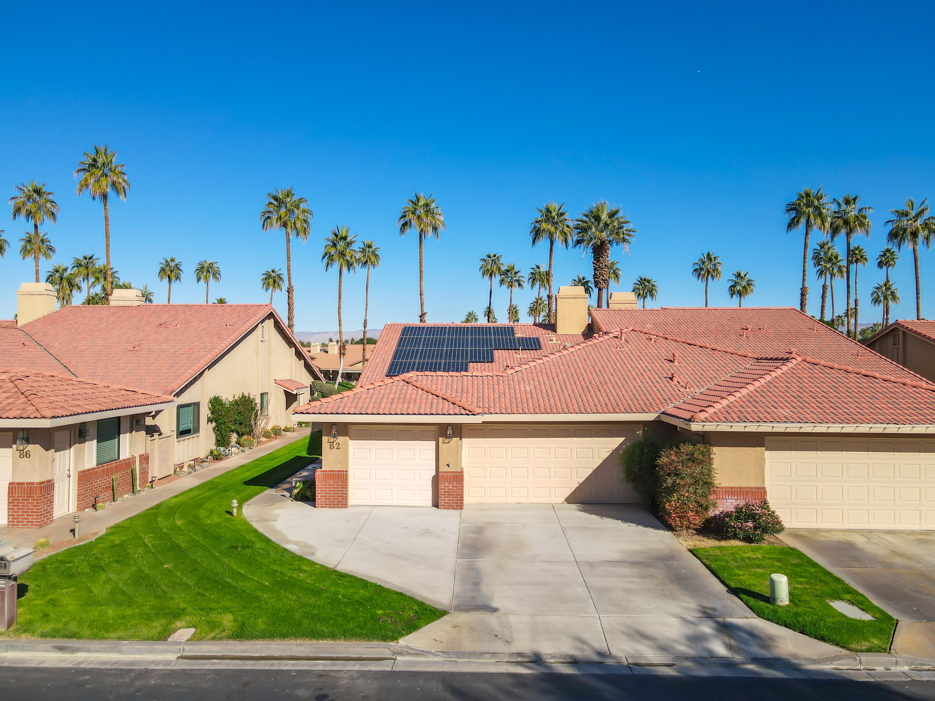 82 Conejo Circle Palm Desert, CA 92260 - Photo 37 of 58 an aerial view of a house with a yard