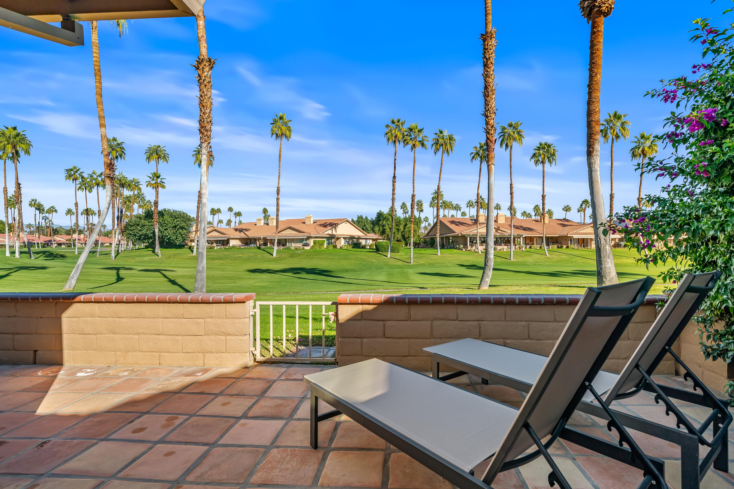 82 Conejo Circle Palm Desert, CA 92260 - Photo 44 of 58 a view of a patio with a table chairs and a fire pit