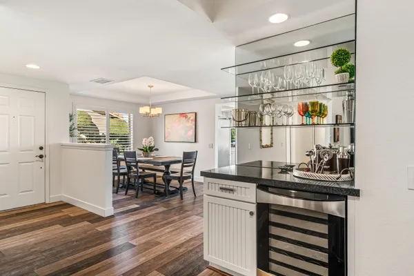 a kitchen with a chair and cabinets