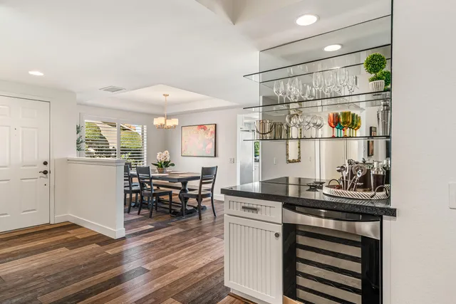 a kitchen with a chair and cabinets