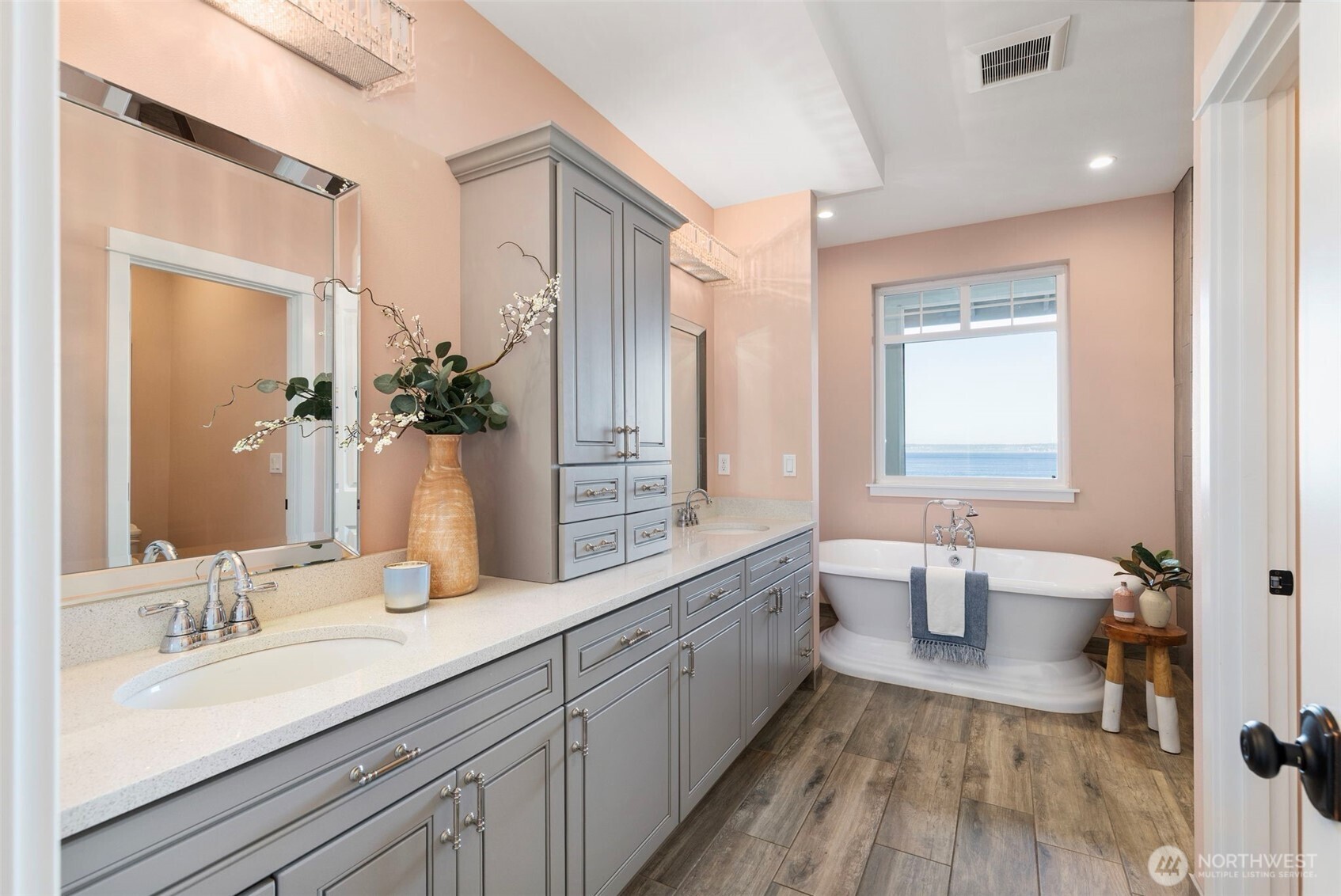 32326 Hoffman Road Northeast Kingston, WA 98346 - Photo 21 of 40 a spacious bathroom with a double vanity sink a large mirror and a bathtub
