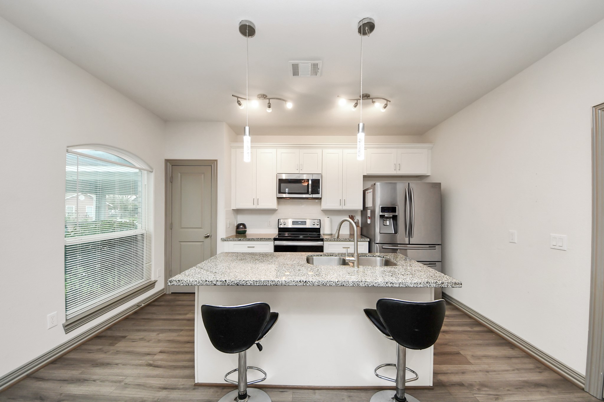 5334 Pershing Street Houston, TX 77033 - Photo 37 of 43 a kitchen with kitchen island granite countertop a stove a sink and a refrigerator