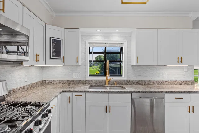 a kitchen with granite countertop a sink and a stove