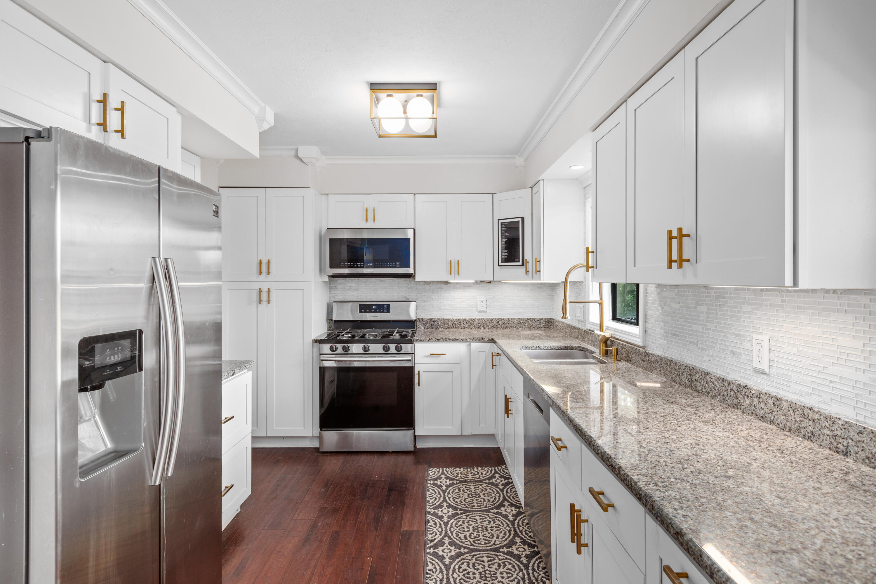 4152 Oakmont Court Crown Point, IN 46307 - Photo 12 of 34 a kitchen with stainless steel appliances granite countertop a refrigerator stove and sink