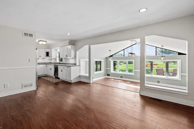 a view of kitchen with furniture and wooden floor