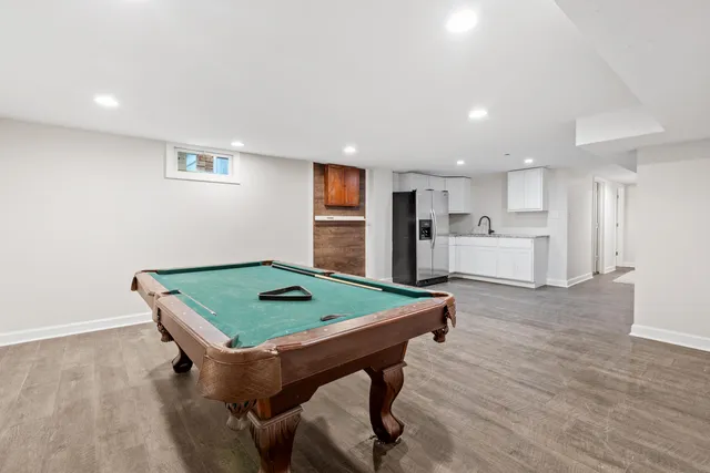 a room with furniture pool table and window