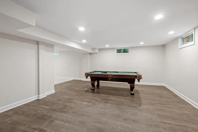 a kitchen with white cabinets and refrigerator