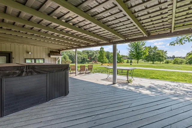 a front view of a house with a yard table and chairs