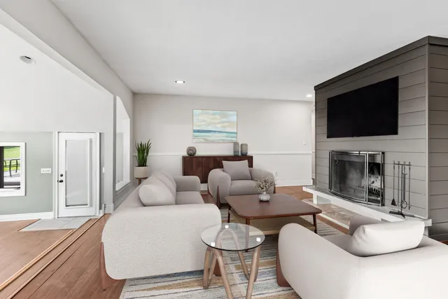 a living room with fireplace furniture and a flat screen tv