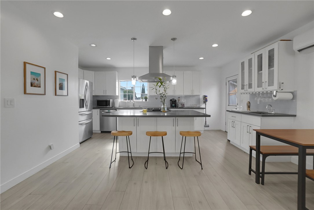3541 Gibson Road El Monte, CA 91731 - Photo 13 of 38 a kitchen with stainless steel appliances kitchen island granite countertop a table chairs sink and cabinets