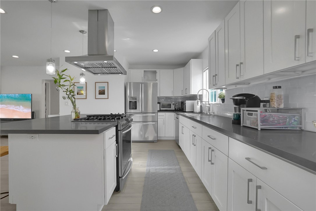3541 Gibson Road El Monte, CA 91731 - Photo 18 of 38 a large kitchen with stainless steel appliances granite countertop a sink and cabinets