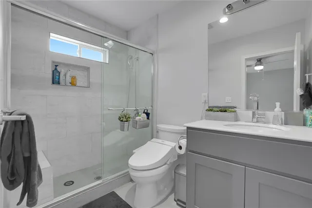 a bathroom with a toilet a sink and shower