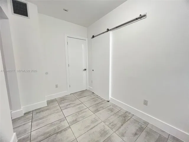 a view of a storage and utility room with two washing machine