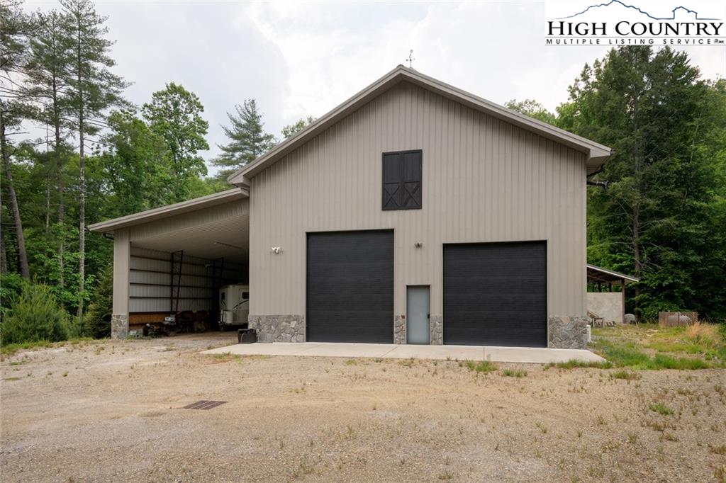 1520 Meadow Road Ferguson, NC 28624 - Photo 32 of 44 a view of a house with a yard and garage