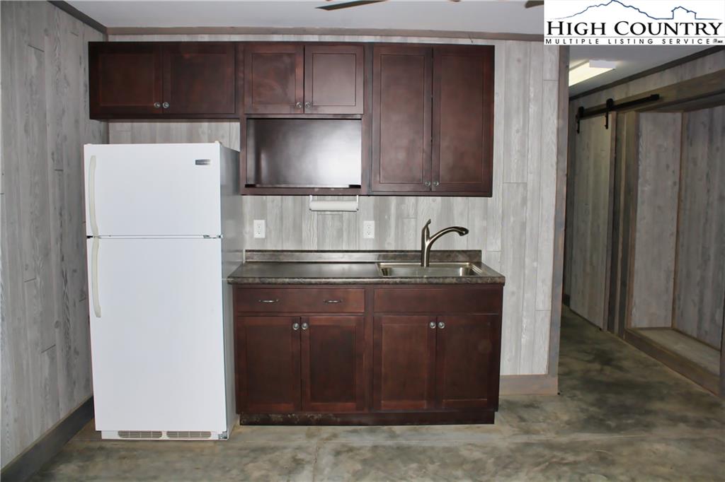 1520 Meadow Road Ferguson, NC 28624 - Photo 7 of 44 a kitchen with a refrigerator and a sink