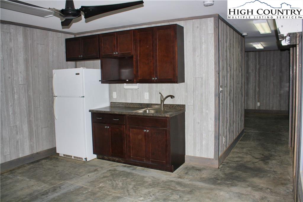 1520 Meadow Road Ferguson, NC 28624 - Photo 8 of 44 a kitchen with a refrigerator and a sink