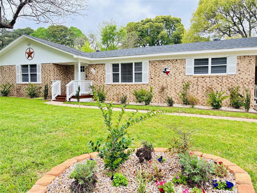 a front view of house with yard and green space