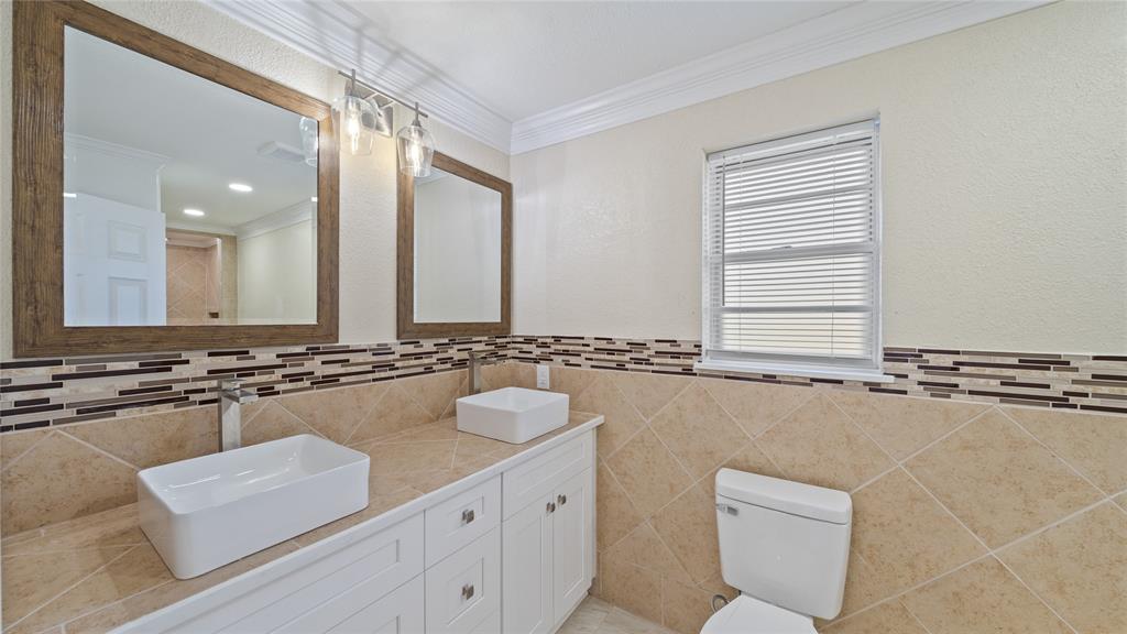 539 Edmonson Avenue Athens, TX 75751 - Photo 11 of 21 a bathroom with a granite countertop sink a large mirror and a bathtub