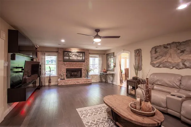 a living room with furniture a flat screen tv and a fireplace