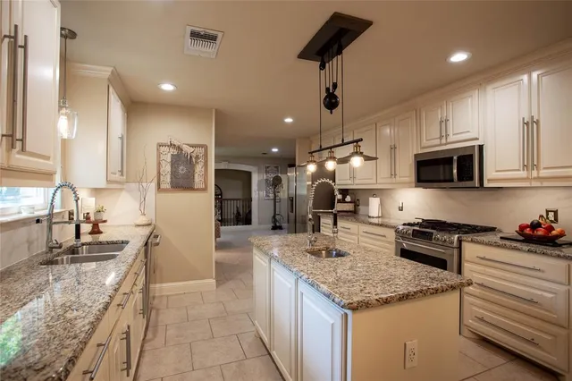 a kitchen with granite countertop a stove and a sink