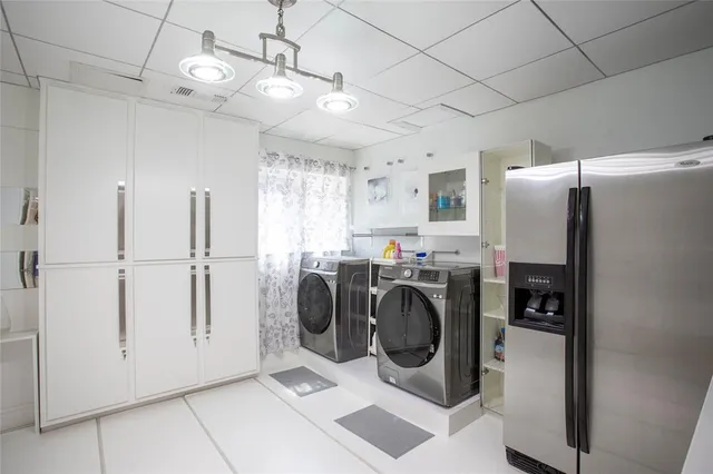 a view of a refrigerator and washer in a kitchen