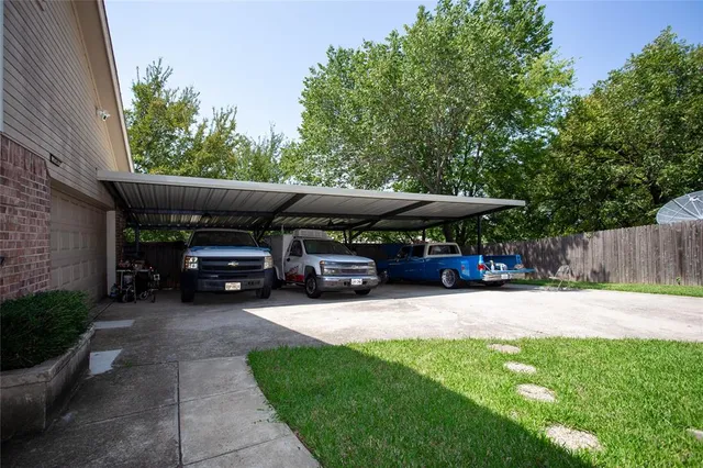 a view of house with backyard and car parked
