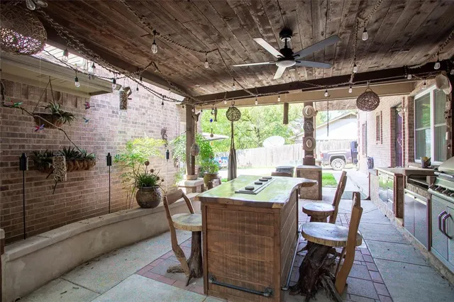 a dining room with furniture and a floor to ceiling window