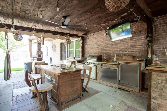 a dining table chair with granite countertop a stove a sink and dishwasher